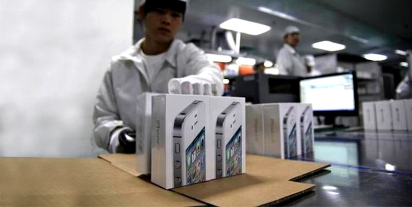 Workers handling iPhone in a factory