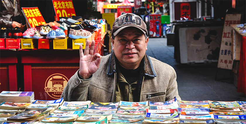 Chinese open air shop retailer waving hand